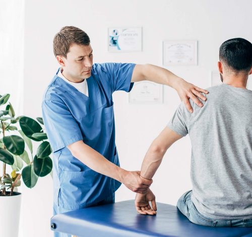 physiotherapist-massaging-arm-of-patient-on-massag-2024-11-01-05-24-00-AEMUJS7.jpg